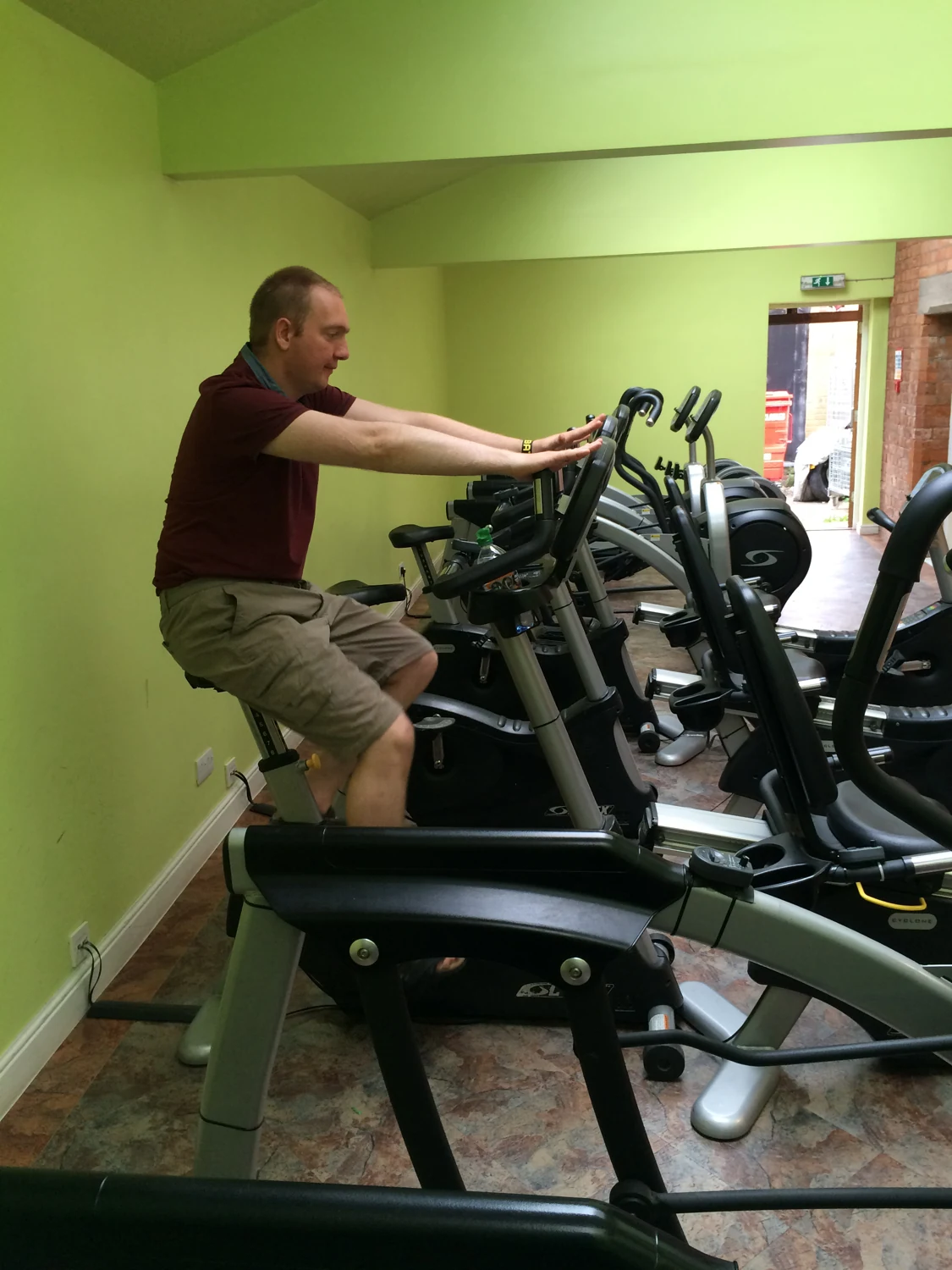 A man exercising on a stationary bicycle