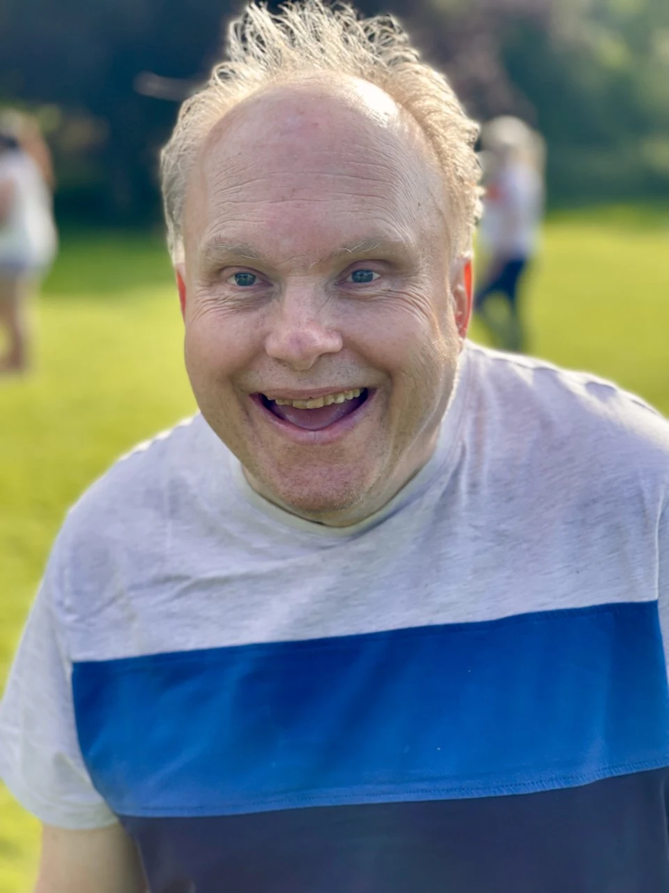 A man smiling outdoors
