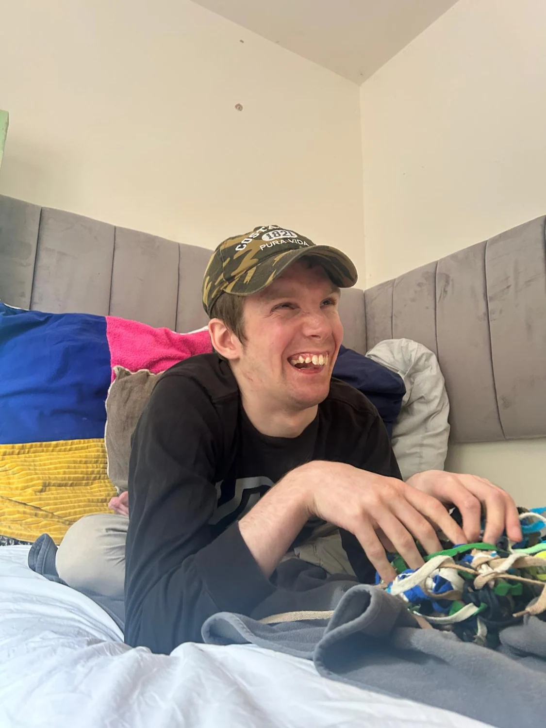 A man smiling while relaxing on a sofa