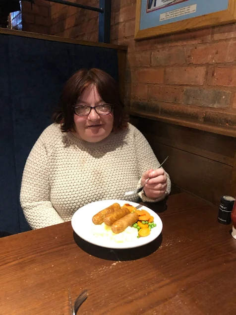 A woman enjoying a meal at a restaurant