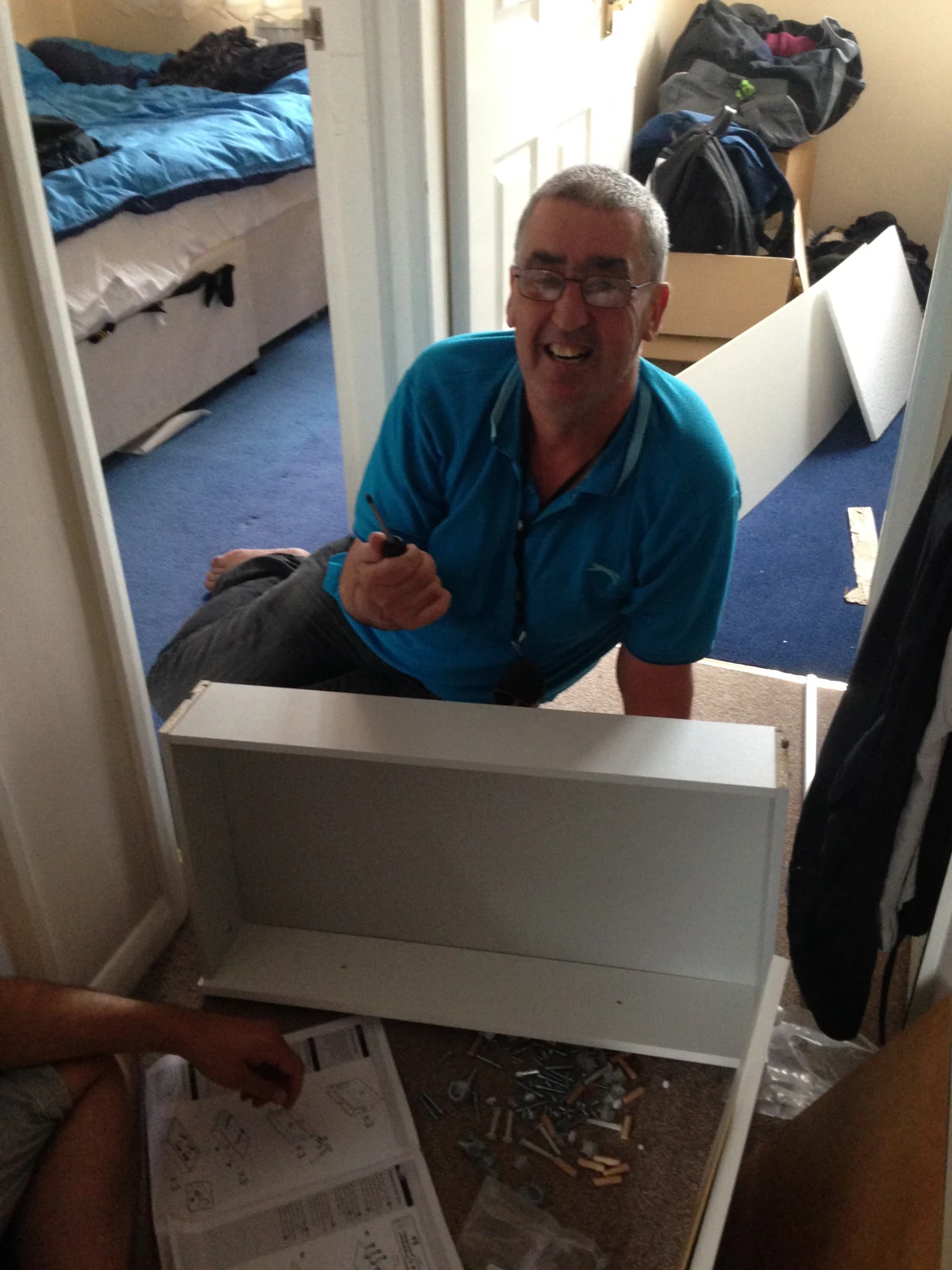 A man assembling furniture at home