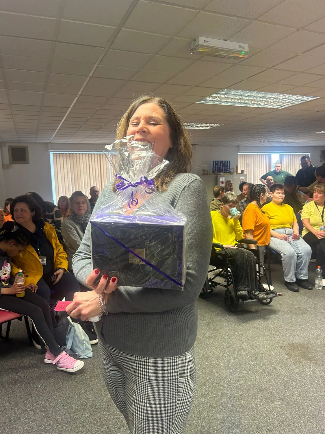 A woman carrying a bag during a group gathering