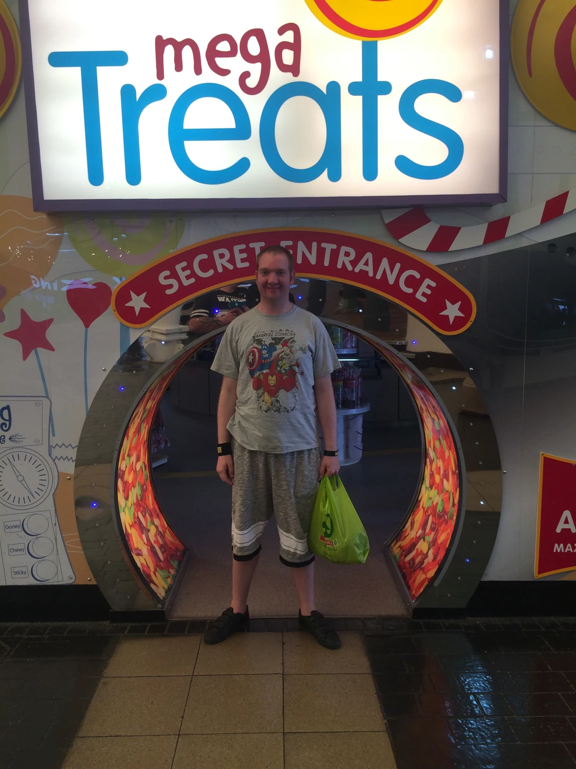 A man standing by a seaside sweets display