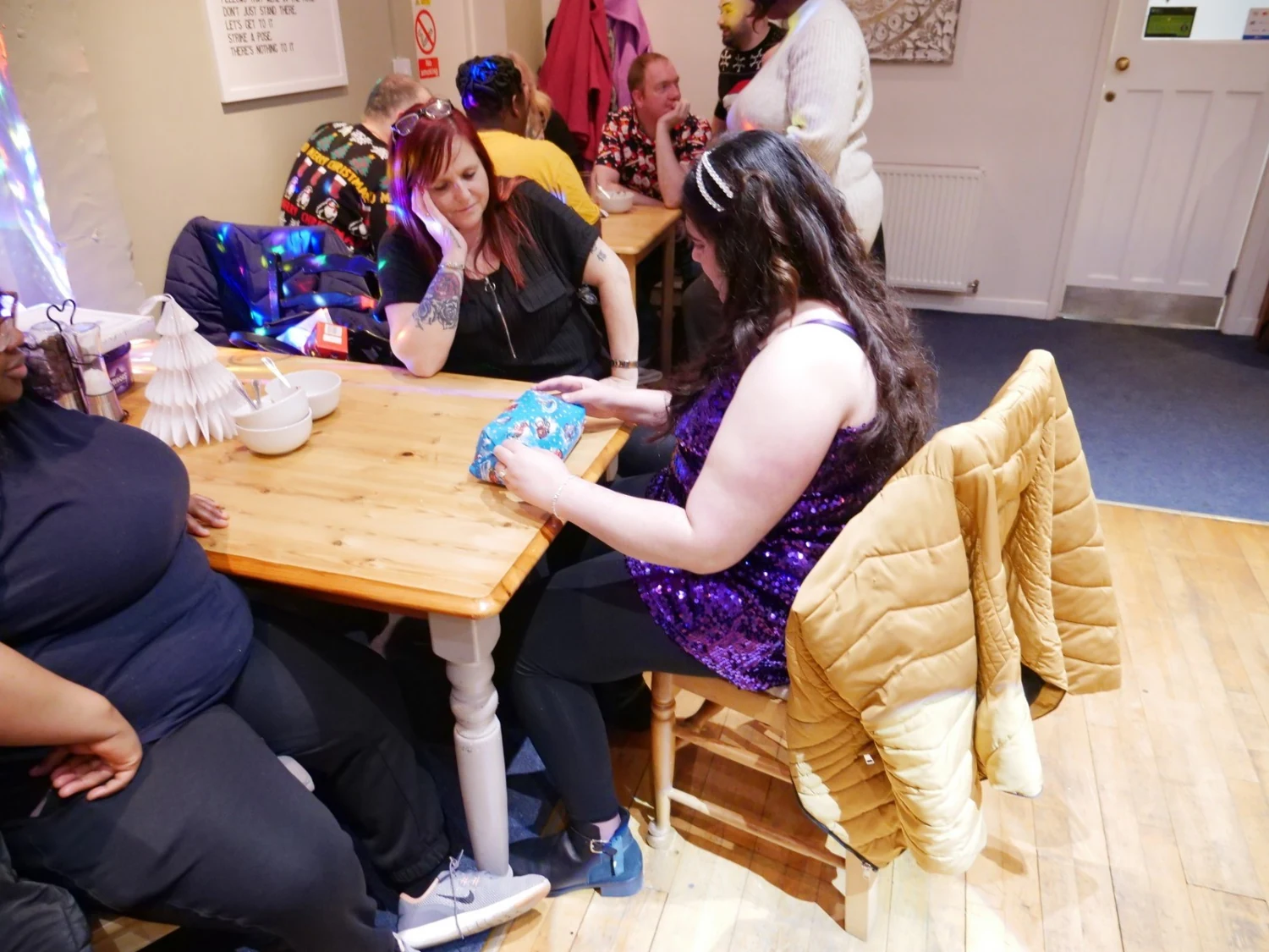 People chatting around a table at a celebration