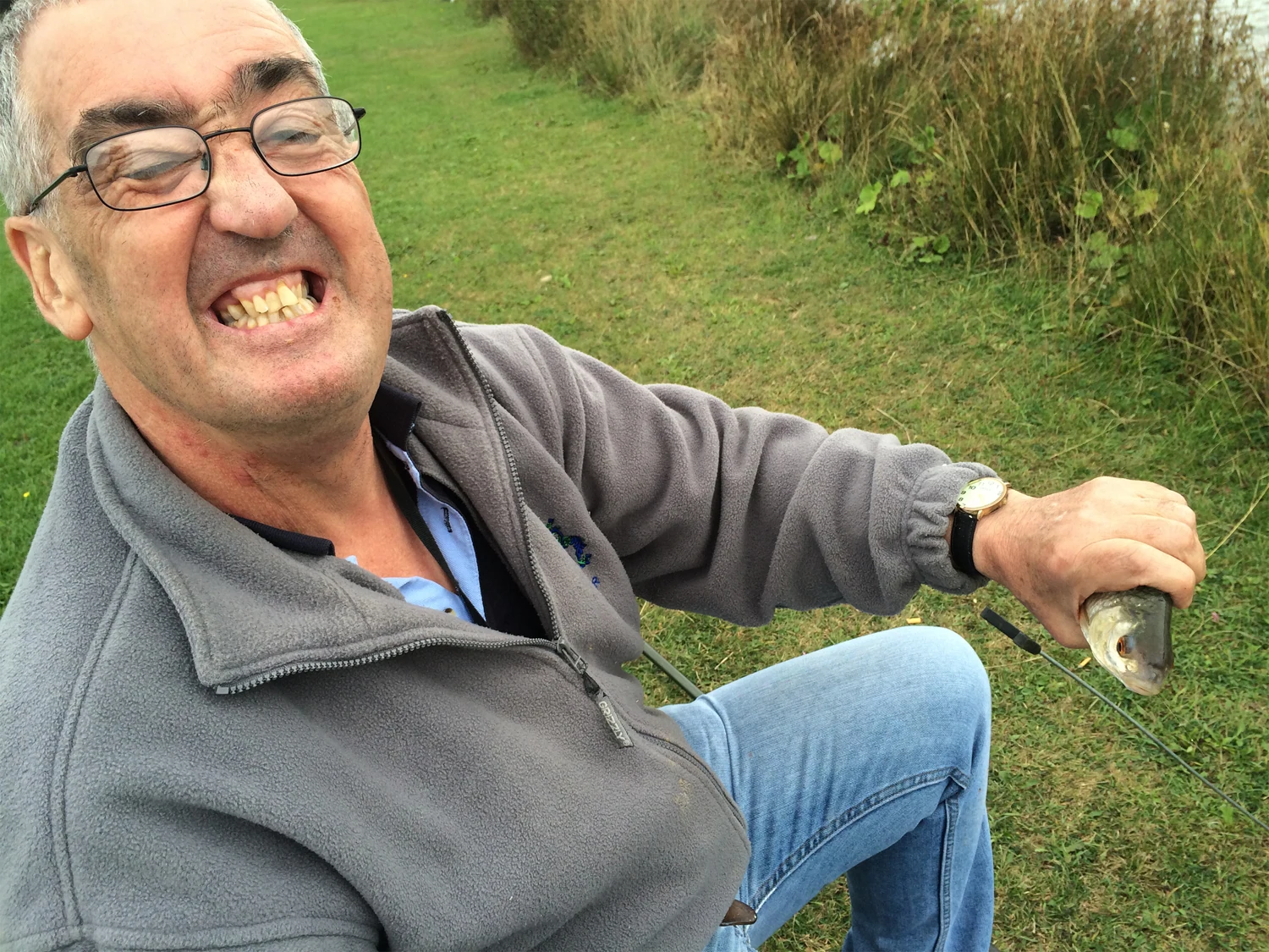 A man smiling during a fishing trip