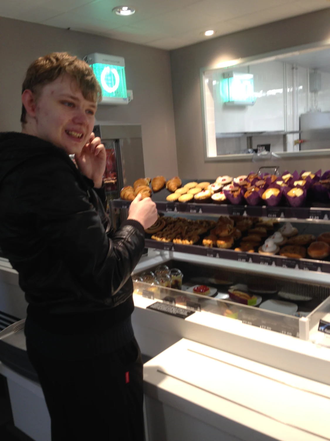 A man selecting produce in a supermarket