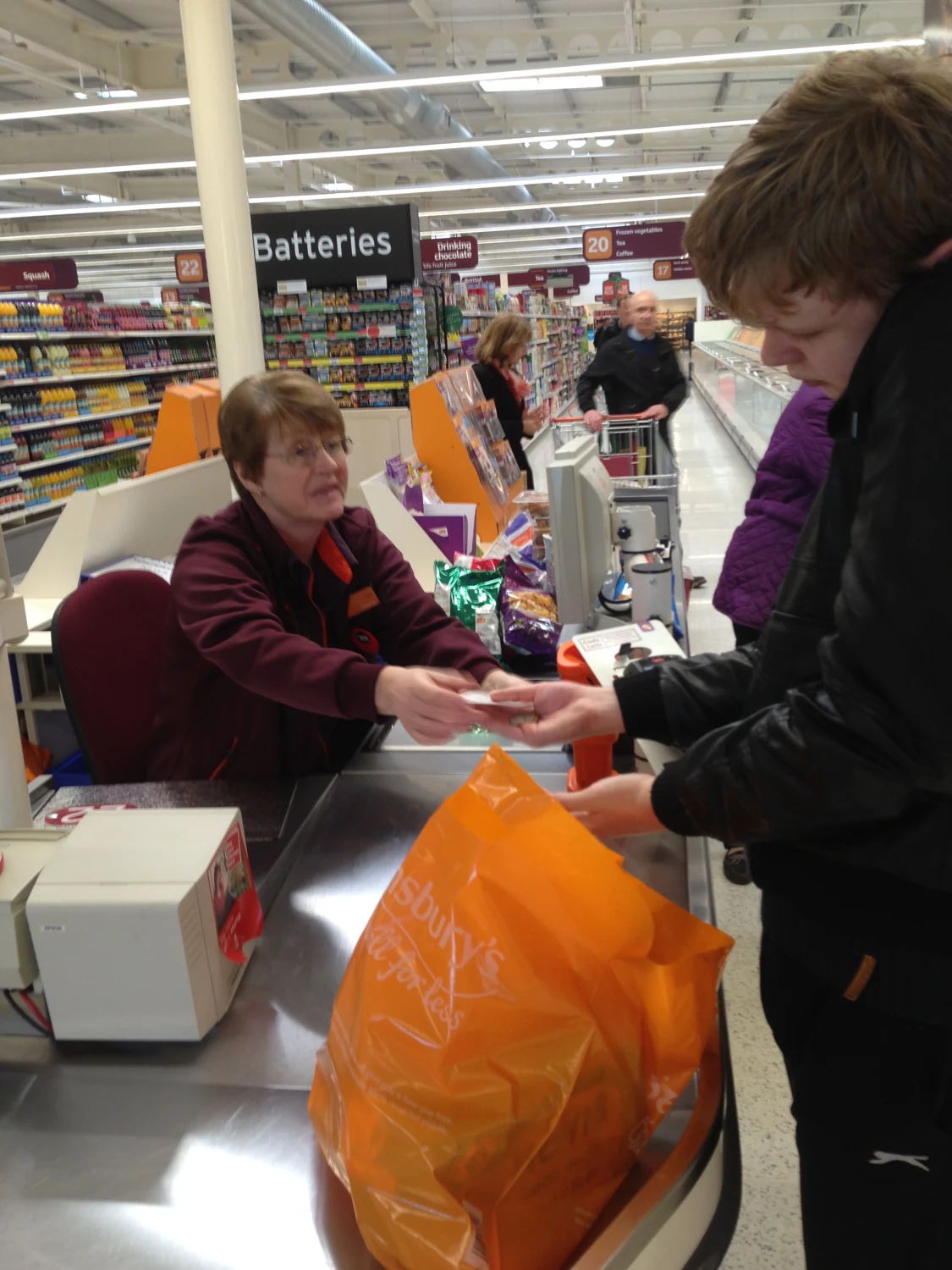 People packing groceries at a checkout