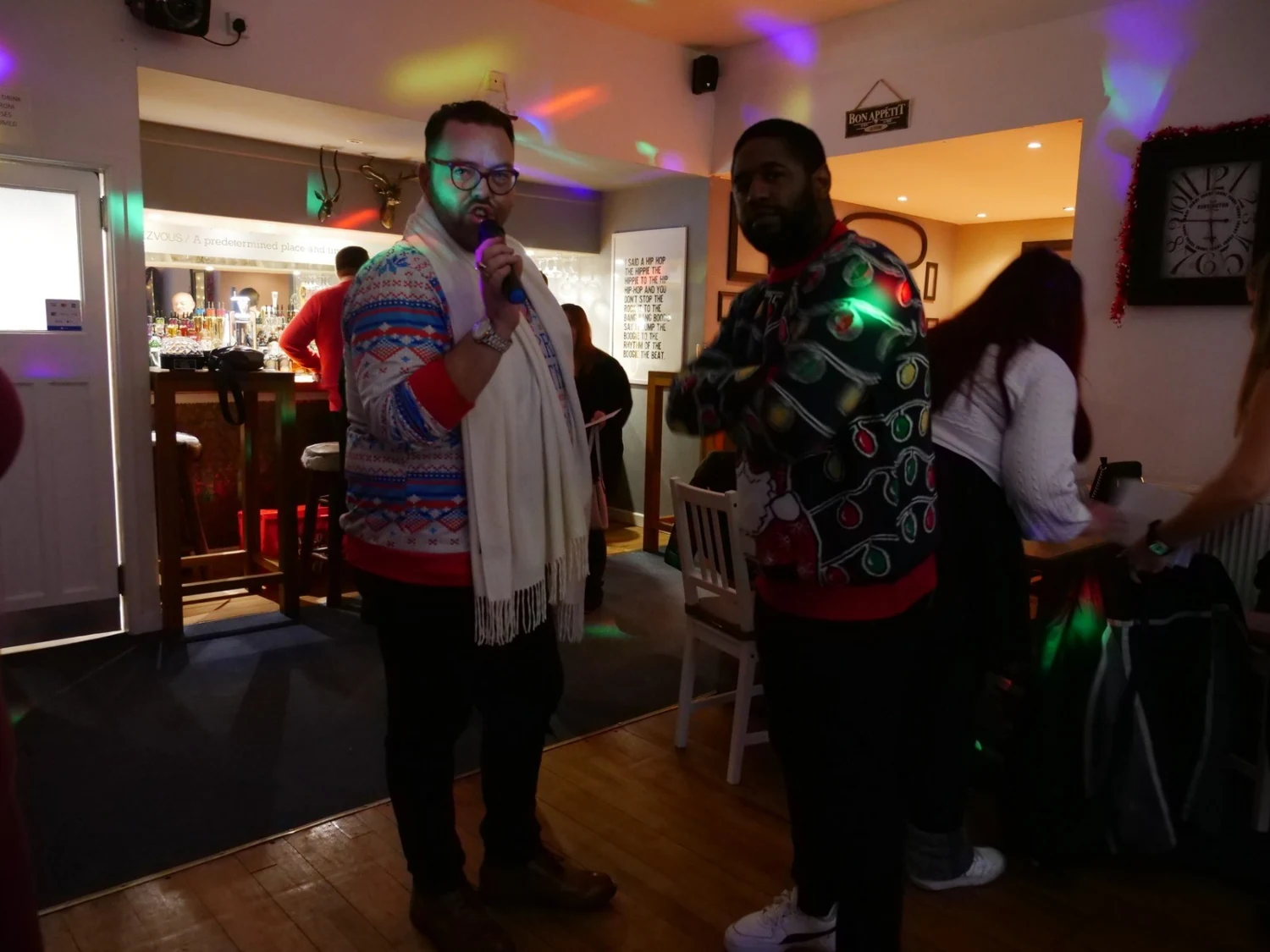 Two people enjoying music at a party