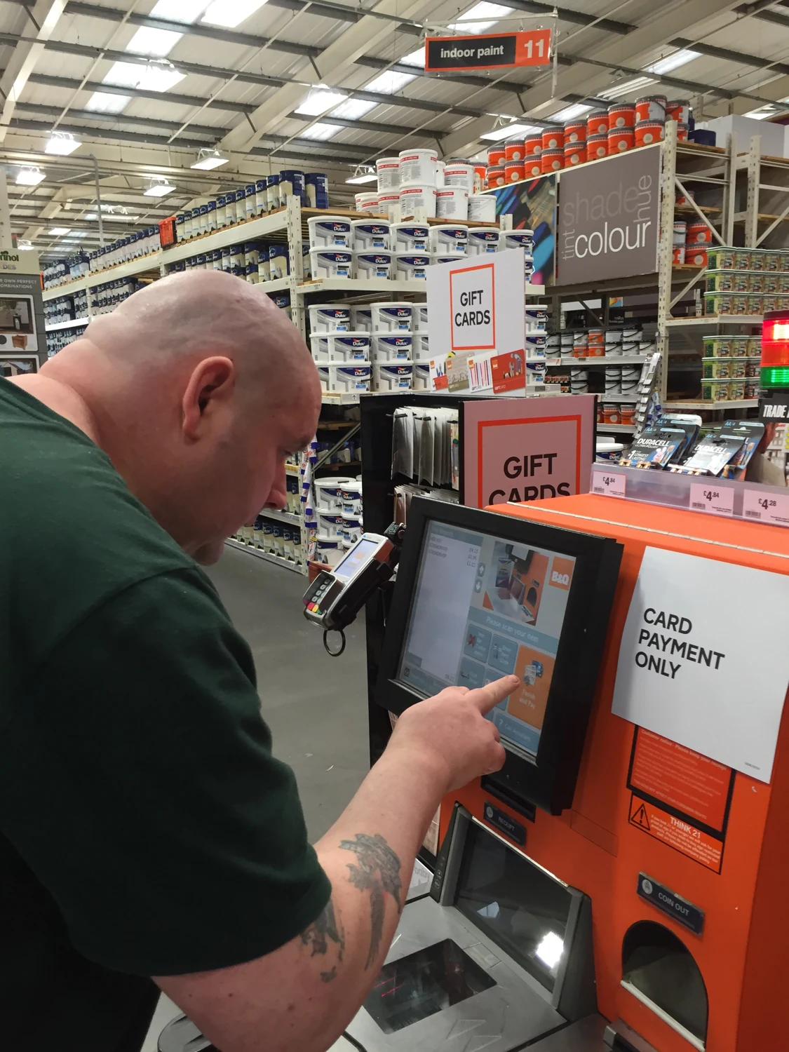 A man using a self-service machine in a shop