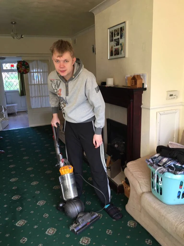 A man vacuuming a room