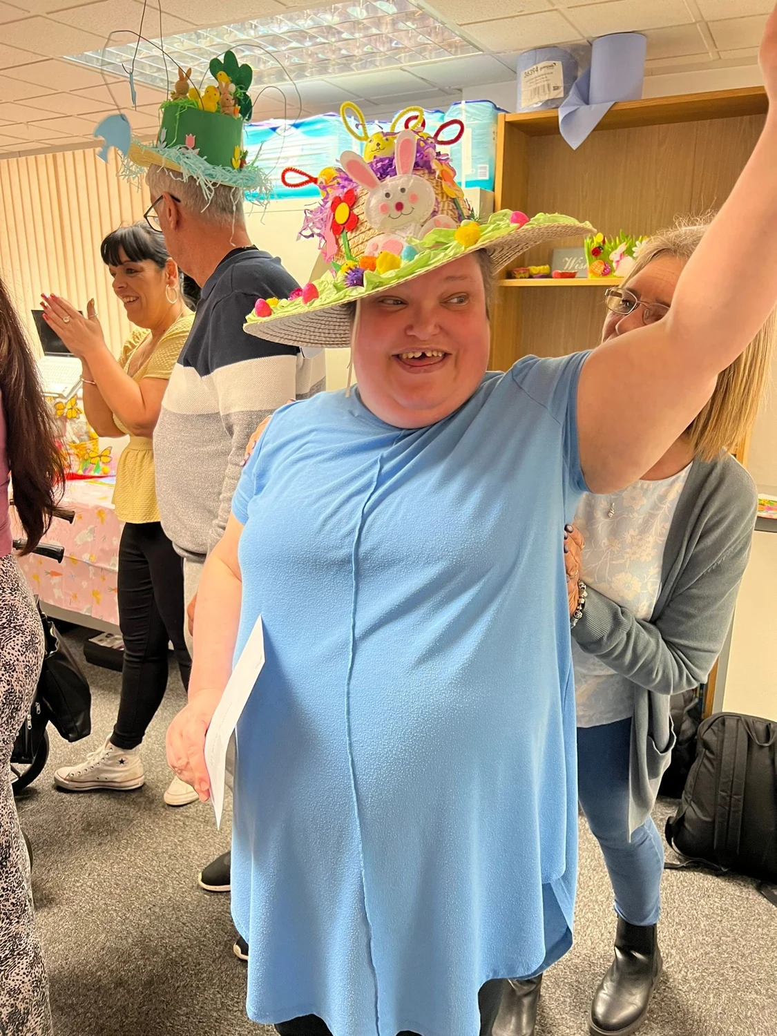 A man celebrating in a colourful party hat
