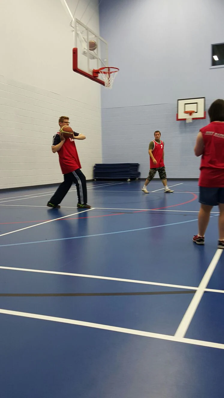 People playing basketball in a sports hall