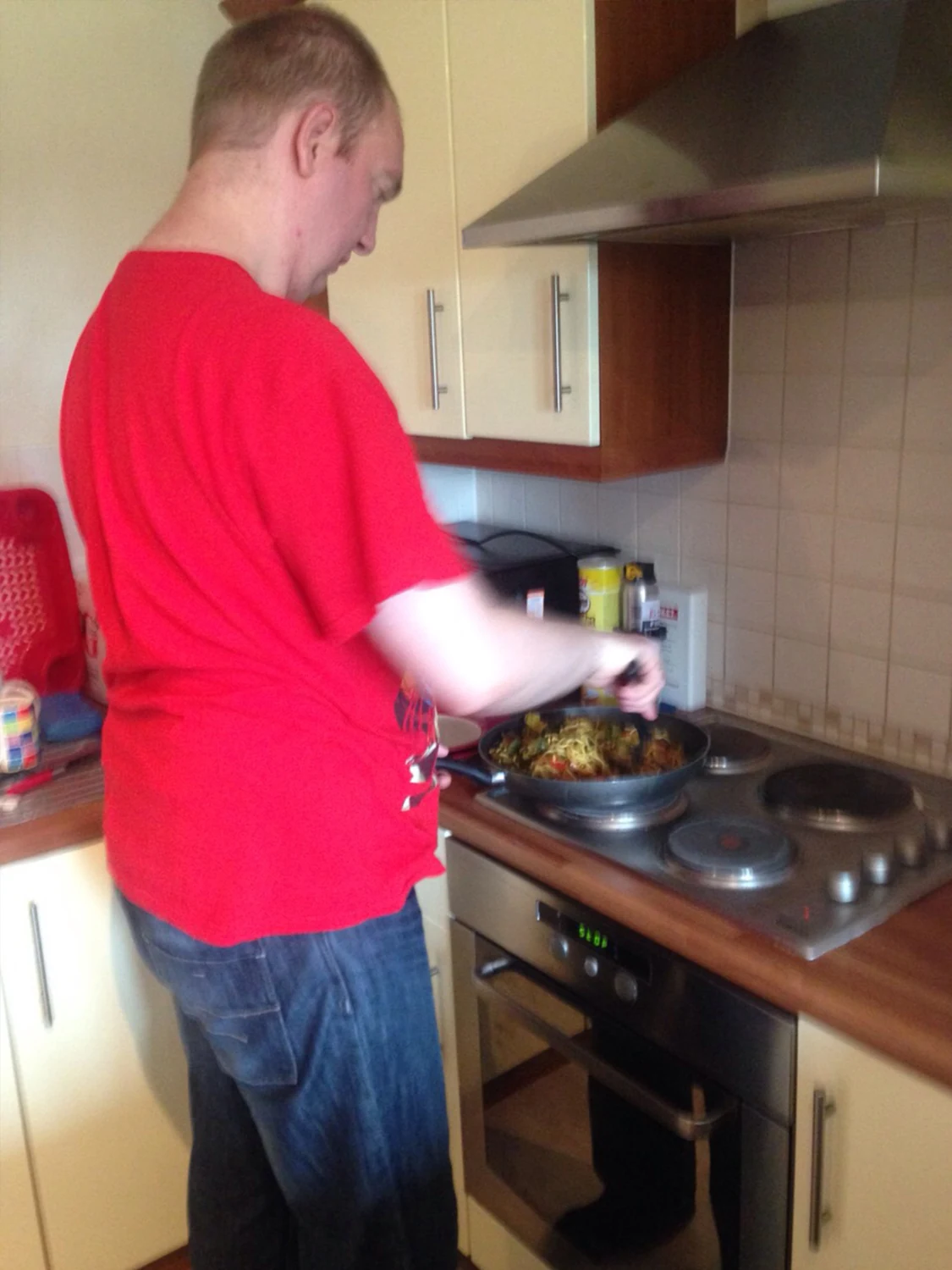 A man cooking at a hob